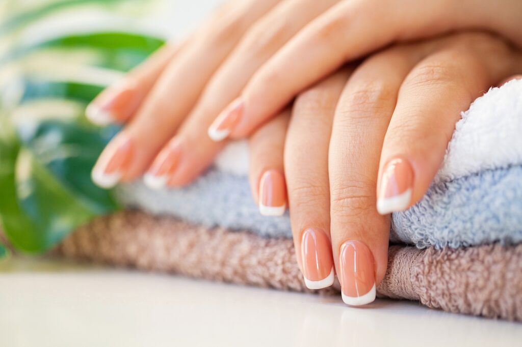 spa-beautiful-woman-s-nails-with-french-manicure-beauty-studio